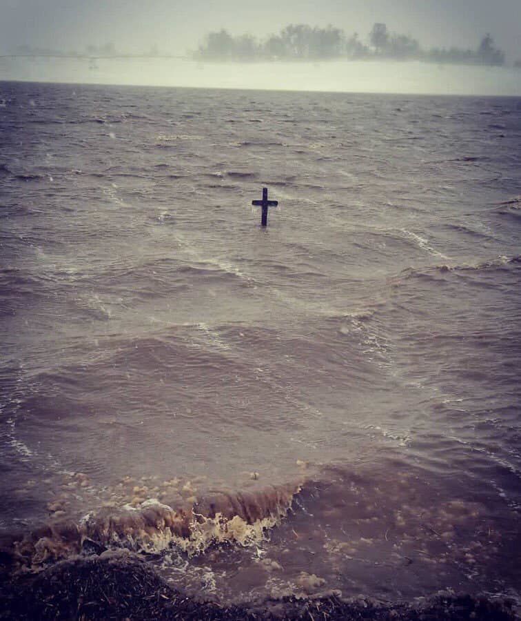 Cross in water by Highway 68